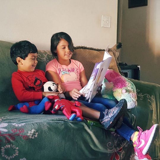 Photo of kids reading a book